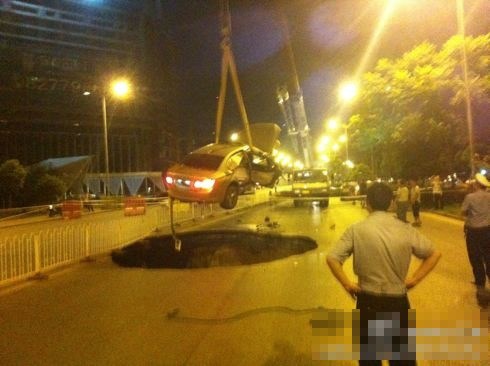吊車將墜入塌陷坑的汽車吊出。圖/末代小王爺